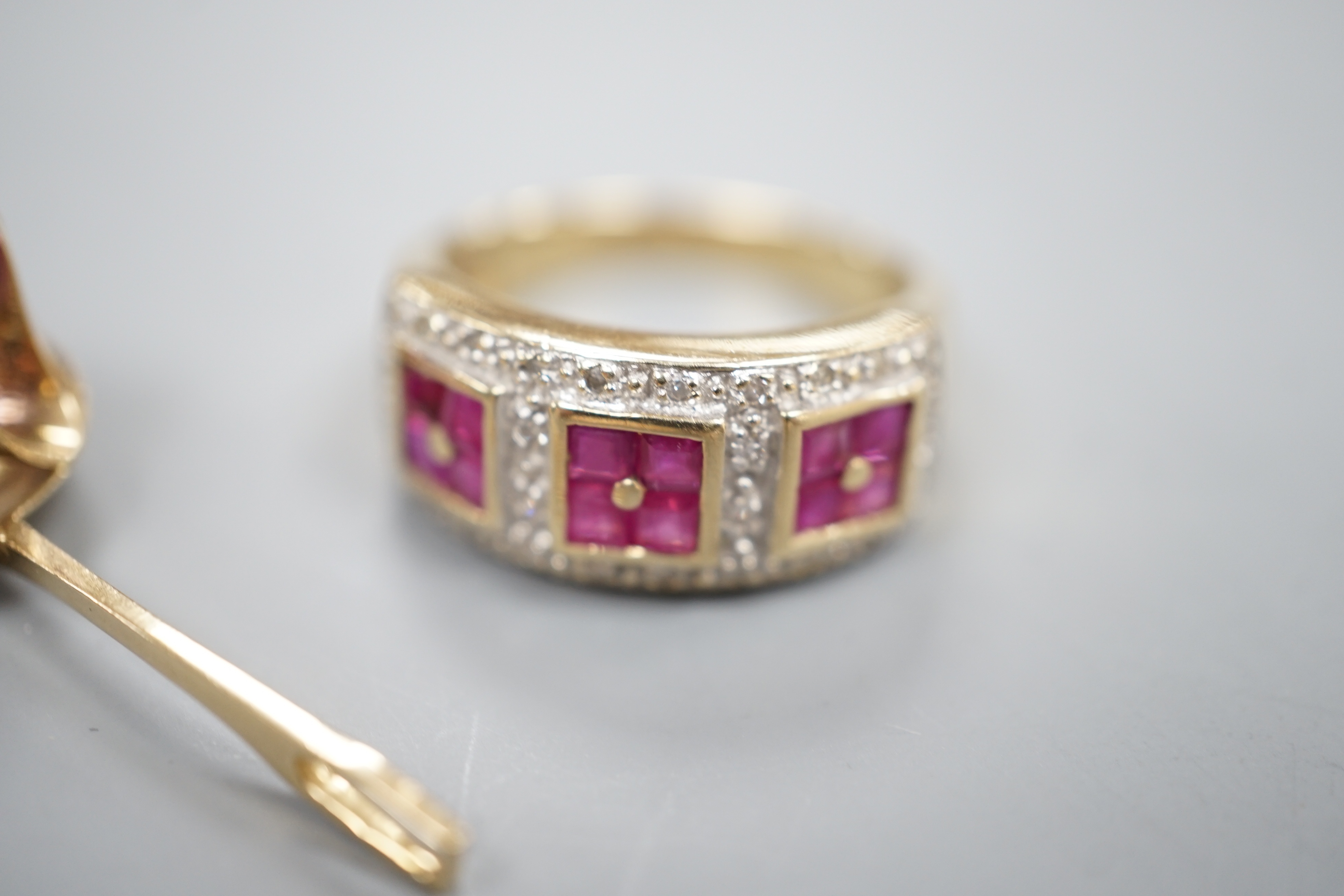 A modern 9ct gold, ruby and diamond cluster ring and a modern yellow metal and gem set pendant, gross 7.8 grams.